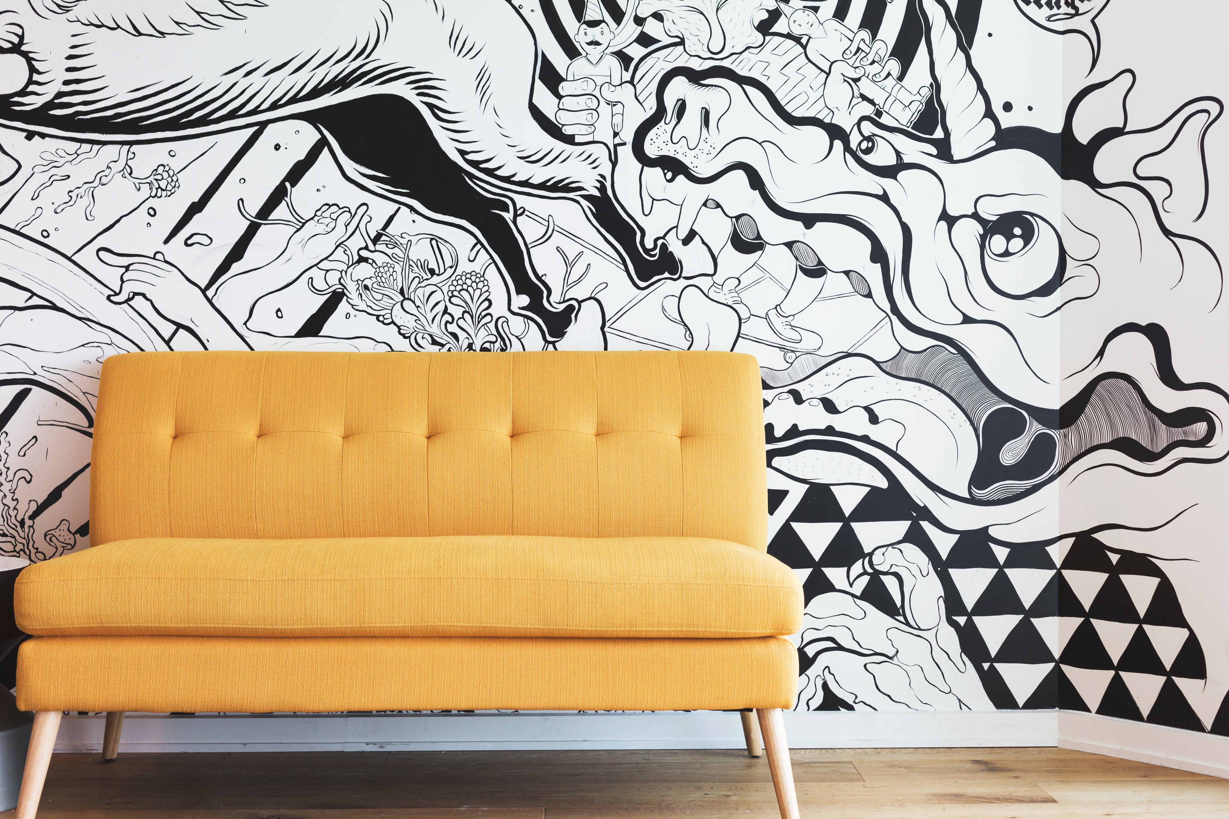 yellow-couch-by-black-and-white-mural.jpg